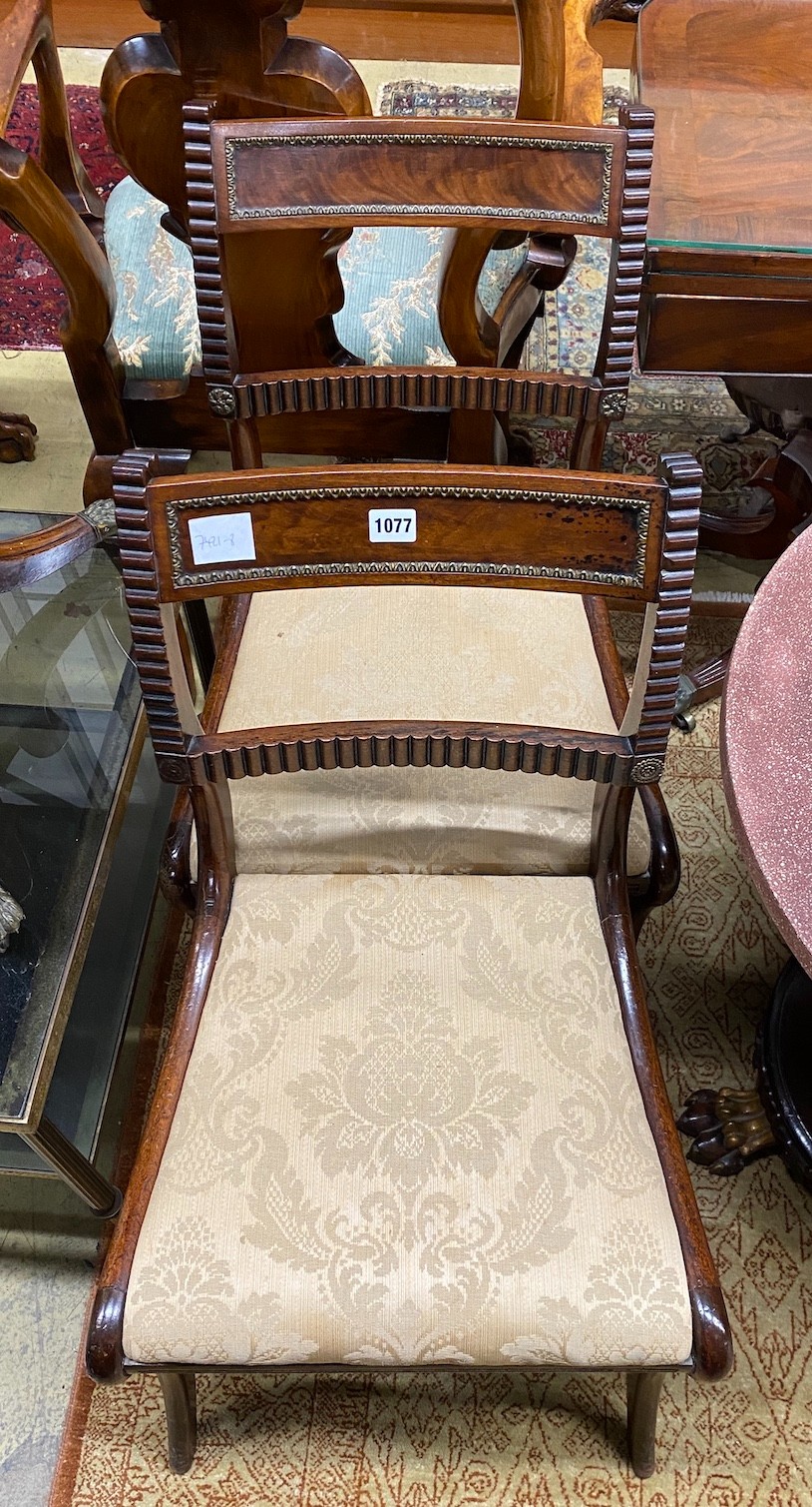 A pair of Regency brass mounted mahogany dining chairs